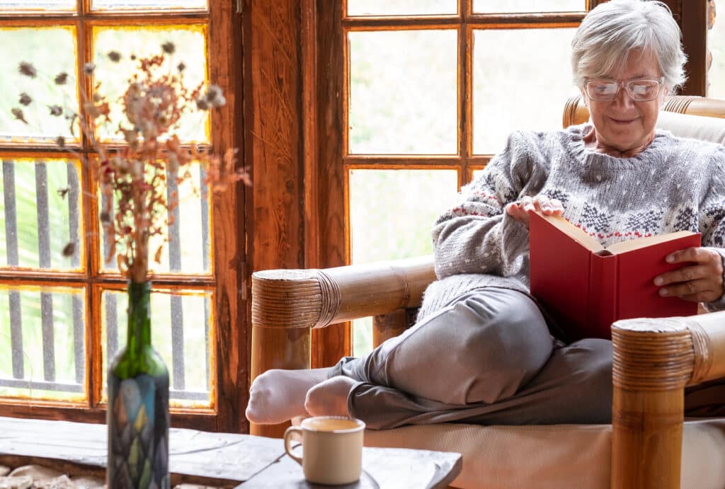 Companion care at home supports seniors enjoying books for relaxation and brain health